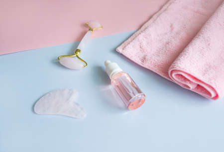 Facial massage attributes: Guasha scraper, cosmetic oil and facial rollerの写真素材