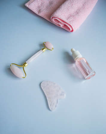 Facial massage attributes: Guasha scraper, cosmetic oil and facial rollerの写真素材