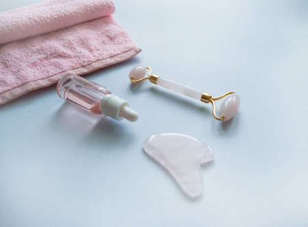Facial massage attributes: Guasha scraper, cosmetic oil and facial rollerの写真素材