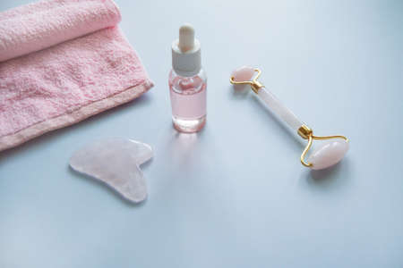 Facial massage attributes: Guasha scraper, cosmetic oil and facial rollerの写真素材