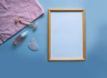 Attributes for massage and a towel, behind an empty wooden frame.の写真素材