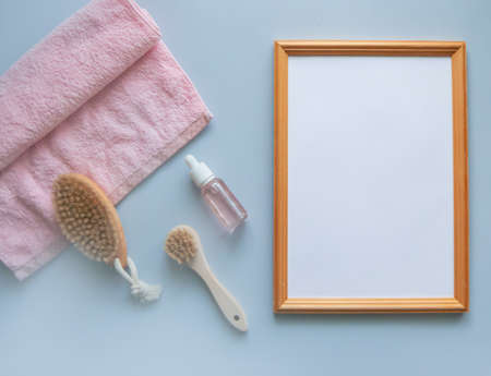 Attributes for massage and a towel, behind an empty wooden frame.の写真素材