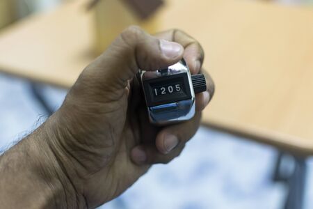 a man hand holding counting machineの写真素材