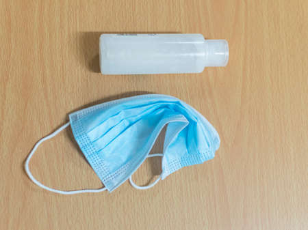 a mask and hand clean liquid on the tableの写真素材