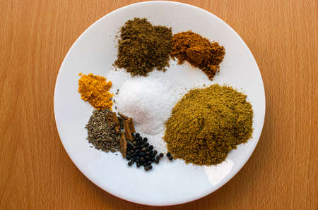 a collection of mix masala in a white plate on a tableの写真素材
