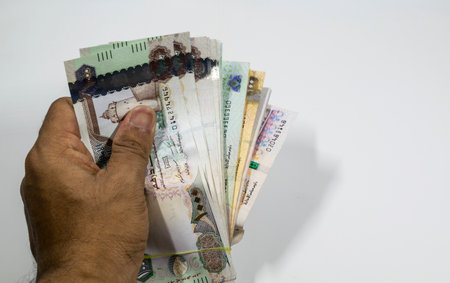 a man counting UAE currency in white background, UAE DIrhams,の写真素材