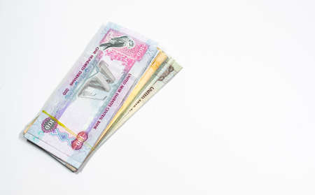 A close up view of United Arab Emirates currency, with white background, UAE Dirhams