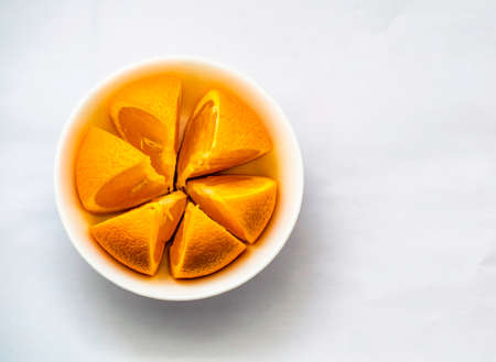 one sliced Orange arranged in a white bowl, Selective focus, Selective focus on subject,