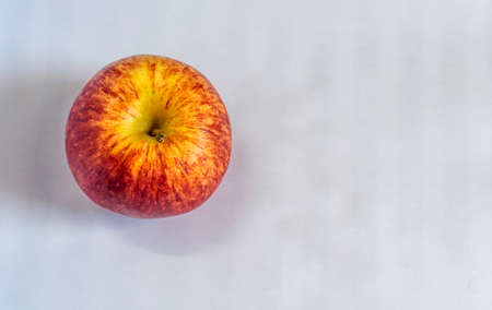 A fresh red apple on a white background,  Selective focus, Selective focus on subject, background blurの写真素材