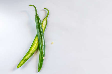 Cut green chili on a nice white backgound,  Selective focus, Selective focus on subject, background blurの写真素材