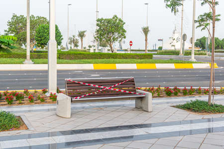 a sealed park bench from preventing people from using due to coronavirus outbreak, covid 19 lockdownのeditorial素材