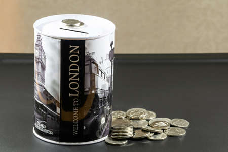 a coin collection box and some coins in a black background
