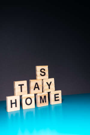 the word corona and stay home arranged nicely on a colorful background with space for textsの写真素材