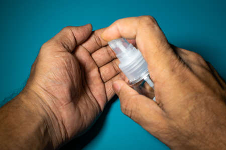 a man hand cleaning hand with sanitizer to prevent corona virus, covid 19の写真素材