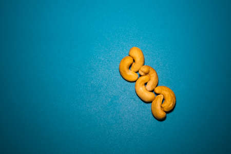 some cashew nuts arranged in a blue backgroundの写真素材