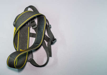 An isolated view of DSLR camera tie in a gray backgroundの写真素材