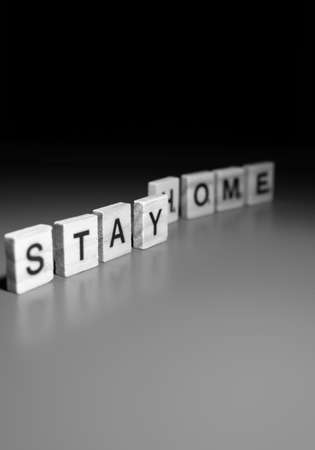 the word corona and stay home arranged nicely on a colorful background with space for textsの写真素材