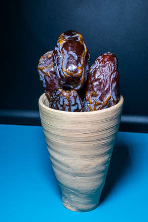 some fresh dates in a clay pot