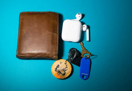 a wallet, airpods and keys left in beautiful background