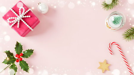 Christmas and New Year background with candy canes, holly berry and gift box on pink background.の素材