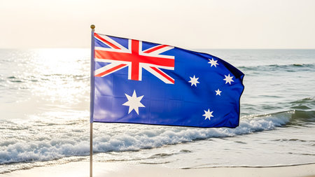 Australian flag waving on the beach at sunset time. Vacation conceptの素材