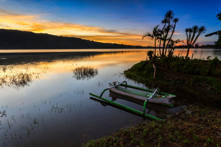 traditional fisherman boat parked at the river side during sunrise at Bali, Indonesiaの写真素材