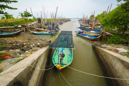 Colorful traditional fisherman boat docked at the tributary side at Yan beach, Kedah, Malaysia. Shoot during hot sunny dayの写真素材