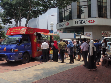 Kuala Lumpur, Malaysia. April 5 2018. Office workers queuing to buy take-away lunch from the food-truck in Kuala Lumpur, Malaysia.のeditorial素材