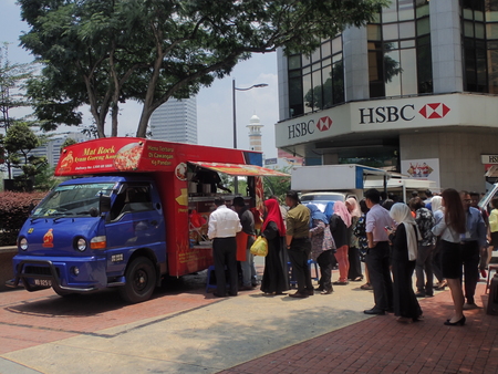 Kuala Lumpur, Malaysia. April 5 2018. Office workers queuing to buy take-away lunch from the food-truck in Kuala Lumpur, Malaysia.のeditorial素材