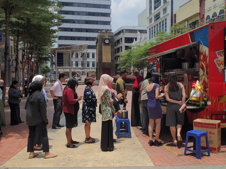 Kuala Lumpur, Malaysia. April 5 2018. Office workers queuing to buy take-away lunch from the food-truck in Kuala Lumpur, Malaysia.のeditorial素材