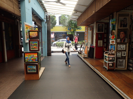 Kuala Lumpur, Malaysia. April 5 2018. A woman walks at Central Market Art Lane passing the studio-shoppes that flanks the pedestrianized walkway between the Central Market building and Annexe building in Kuala Lumpur, Malaysia.のeditorial素材