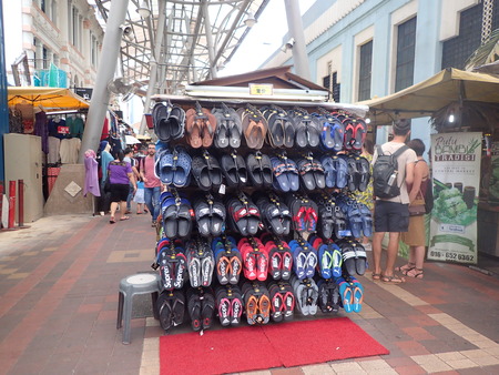 Kuala Lumpur, Malaysia. April 5 2018. Knockoff slippers, sandals and shoes are openly sell at a stall in Kasturi Walk which is a semi covered pedestrianized street of Central Market, Kuala Lumpur.のeditorial素材