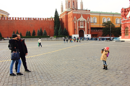 Moscow Russia. October 13 2015. Little girl taking photo of her parent using SLR camera in Red Square, Moscow, Russia.のeditorial素材