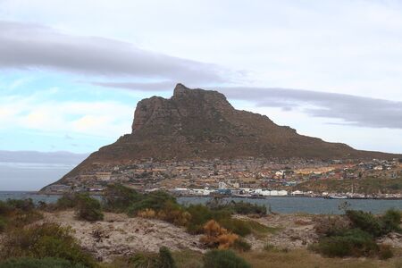 The Sentinel or Hangberg as seen from the sand dune of Hout Bay Beach, in Hout Bay a seaside town in Cape Town, South Africa.の写真素材