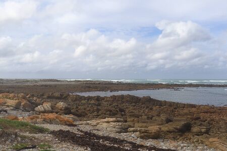 Landscape of coastal rocky headland at Cape Agulhas which is the Southernmost Point of Africa in Cape Agulhas National Park, South Africa.の写真素材