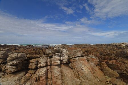 Rock formation in midst of rocky outcrop at the shore of Cape Agulhas which is marks as the Southernmost Point of Africa in Cape Agulhas National Park, South Africa.の写真素材