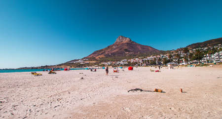 Camps Bay Beach in Camps Bay with people and Lion's Head Mountain in the background at the outskirt of Cape Town, South Africa.のeditorial素材