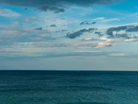 The view of the calm blue sea with beautiful clouds in the blue sky creates a peaceful and soothing atmosphere.の写真素材