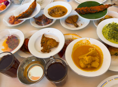Simpel Padang rice consists of several dishes from Padang cuisine served with various side dishes on a white plate at a simple Padang restaurant.の写真素材