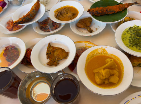 Simpel Padang rice consists of several dishes from Padang cuisine served with various side dishes on a white plate at a simple Padang restaurant.の写真素材