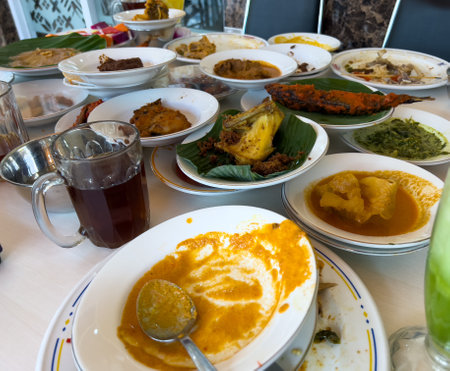 Simpel Padang rice consists of several dishes from Padang cuisine served with various side dishes on a white plate at a simple Padang restaurant.の写真素材