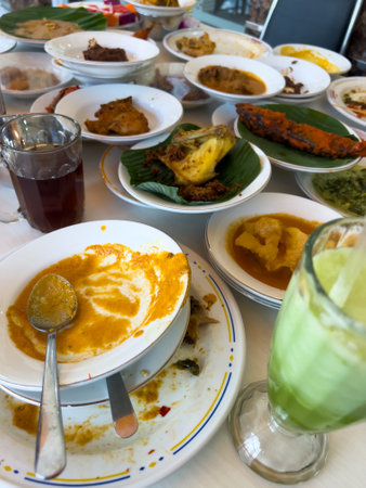 Simpel Padang rice consists of several dishes from Padang cuisine served with various side dishes on a white plate at a simple Padang restaurant.の写真素材