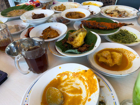Simpel Padang rice consists of several dishes from Padang cuisine served with various side dishes on a white plate at a simple Padang restaurant.の写真素材