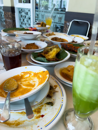 Simpel Padang rice consists of several dishes from Padang cuisine served with various side dishes on a white plate at a simple Padang restaurant.の写真素材