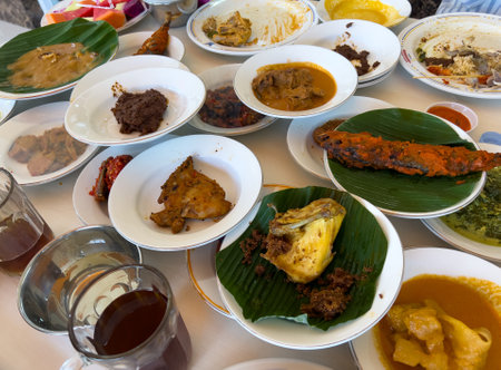 Simpel Padang rice consists of several dishes from Padang cuisine served with various side dishes on a white plate at a simple Padang restaurant.の写真素材