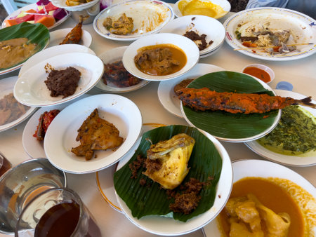 Simpel Padang rice consists of several dishes from Padang cuisine served with various side dishes on a white plate at a simple Padang restaurant.の写真素材