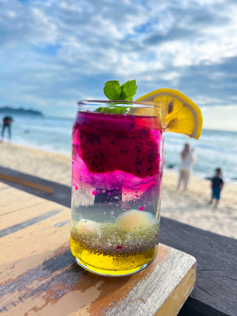 A cold and refreshing dragon fruit cocktail is placed on the table of a restaurant located by the beach, perfect to enjoy and very refreshing.の写真素材