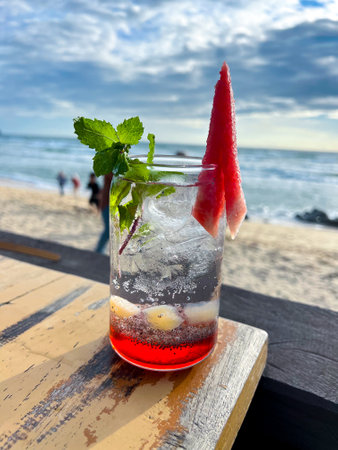 A cold and refreshing watermelon cocktail is placed on the table at a restaurant located by the beach, perfect for enjoying and very refreshing.の写真素材
