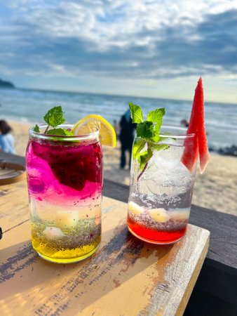 A cold and refreshing watermelon cocktail and dragon fruit cocktail are placed on the table at a restaurant located by the beach, perfect for enjoying and very refreshing.の写真素材