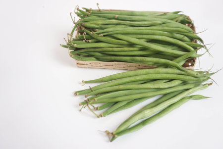 Organic Green beans in a basket on a white background, isolate, copy space